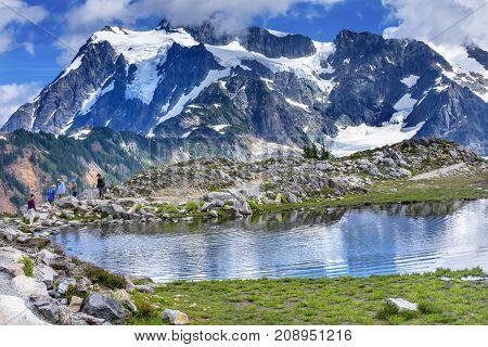 ARTIST POINT, WASHINGTON - AUGUST 19, 2017 Hikers Mount Shuksan Pool Reflection Summer Artist Point Mount Baker Highway Pacific Northwest Washington State Snow Mountain Grass Trees