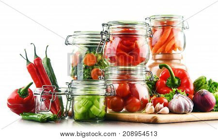 Jars With Marinated Food And Raw Vegetables Isolated On White