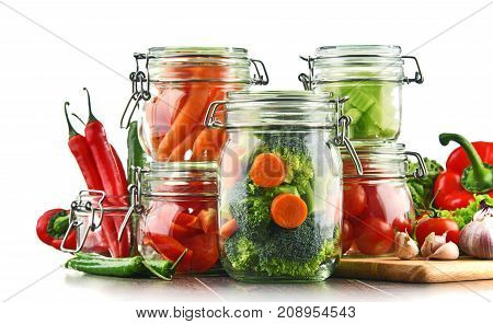 Jars With Marinated Food And Raw Vegetables Isolated On White