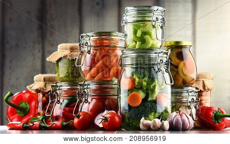 Jars With Marinated Food And Organic Raw Vegetables