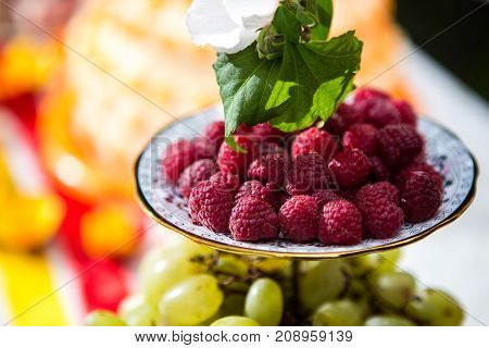 ripe raspberries on a plate close up