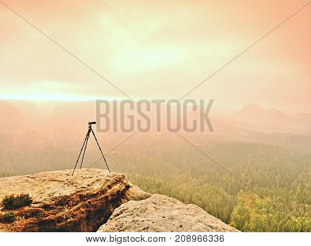 Tripod On The Peak Ready For Photogrpahy. Exposed Rocky View Point. Misty Rainy Autumnal Day