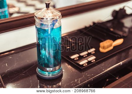 The Tools Of A Barber On The Desktop In Front Of The Mirror