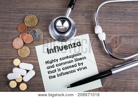 Influenza. Workplace of a doctor. Stethoscope on wooden desk background.