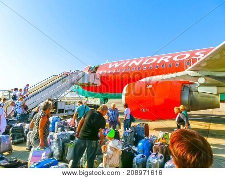 Sharm El Sheikh, Egypt - September 28, 2017: The passenger walking to the rear entrance of airplane at day at Sharm El Sheikh, Egypt on September 28, 2017