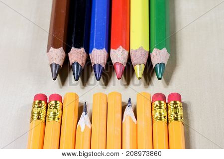 Crayons And Pencil Sharpener On A Wooden Office Table. Crayons With Sharpening Crayons And Pencils O