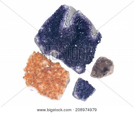 Collection of amethyst and citrine druzy clusters, isolated on white background