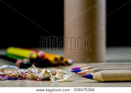 Crayons And Pencil Sharpener On A Wooden Office Table. Crayons With Sharpening Crayons And Pencils O