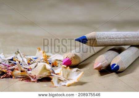 Crayons And Pencil Sharpener On A Wooden Office Table. Crayons With Sharpening Crayons And Pencils O