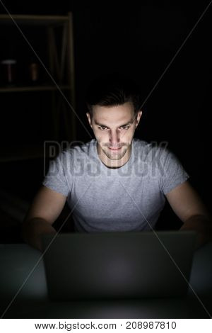 Late Night Internet Addiction Or Working Late Man Using Laptop At A Desk In The Dark