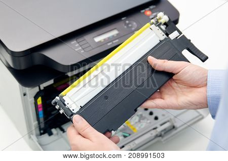 Man Replacing Toner In Laser Printer