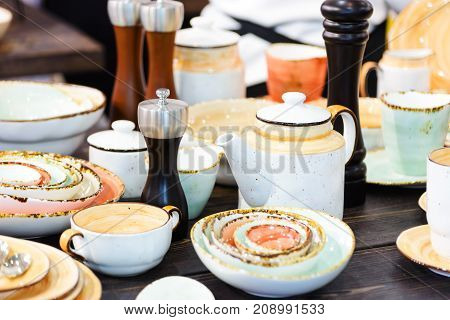 tableware plates salt and pepper shakers teapot mug earthware closeup