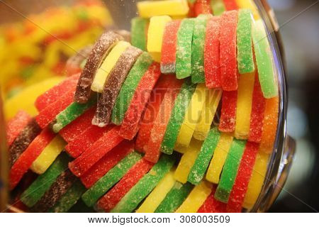 Candy Fruit Slices. Various colors and flavors of imitation fruit slices made from Sugar, and artificial flavors. Fruit Shaped Sugared Candy. 