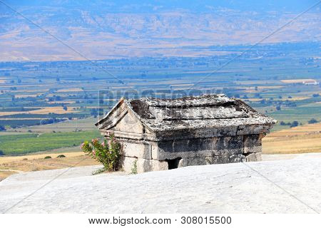 Stone sarcophagus in necropolis on travertine terraces, ancient Hierapolis, Pamukkale, Anatolia, Turkey. UNESCO world heritage site