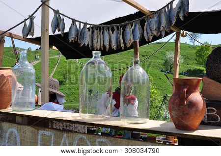 Street Tavern, Counter, Stylized Antique. Dry Fish Ram, Bottles, Jugs, Baskets, Sellers.