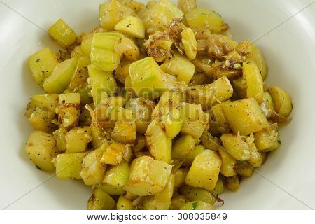 Side Dish Of Peeled And Chopped Zucchini And Summer Yellow Squash With Onions In Serving Bowl