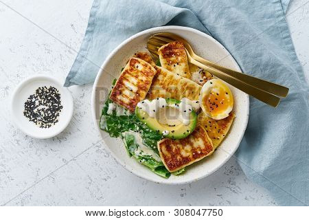 Keto Ketogenic Diet Soft Boiled Eggs With Grilled Haloumi, Avocado And Lettuce, Mediterranean Cuisin