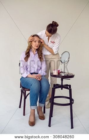 Beautician Aesthetician Glues Kinesio Tape On The Face