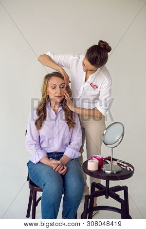 Beautician Aesthetician Glues Kinesio Tape On The Face