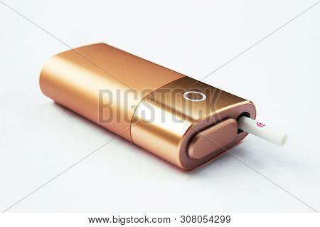 A New Kind Of Electronic Cigarette. Iqos Tobacco Heating System. Lies On A White Background Close-up