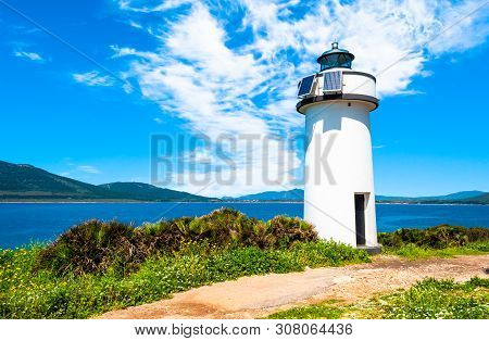 Lighthouse On The Sardinian Coast In A Sunny Day Of Summer