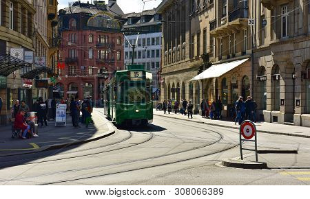 Basel, Switzerland - April 17, 2019. Green Tram Driving Through The Historic Center Grossbasel. City