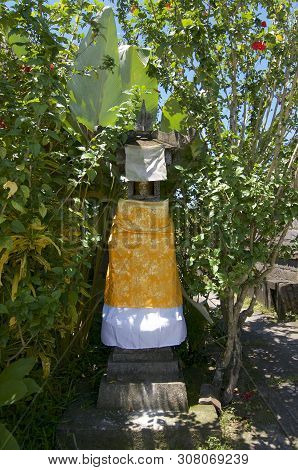 View On A Typical Small Balinese Shrine Covered With Gold And White Drape Where Daily People Place T