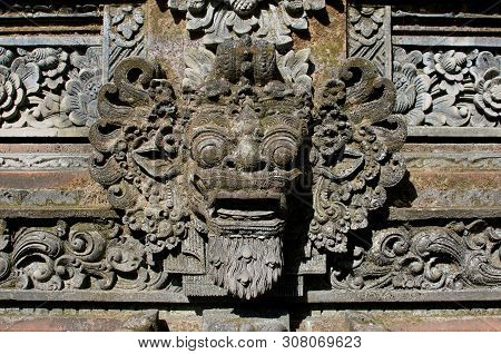 Close Up Picture Of A Typical Balinese Barong Mask Carved In Stone As A Decoration Of A Temple In Ub