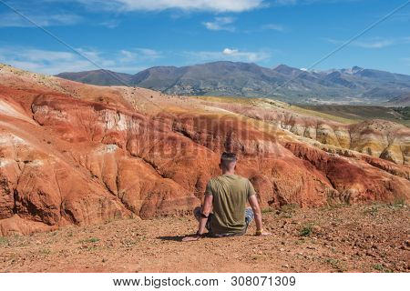 Relaxing man in Valley of Mars landscapes in the Altai Mountains, Kyzyl Chin, Siberia, Russia