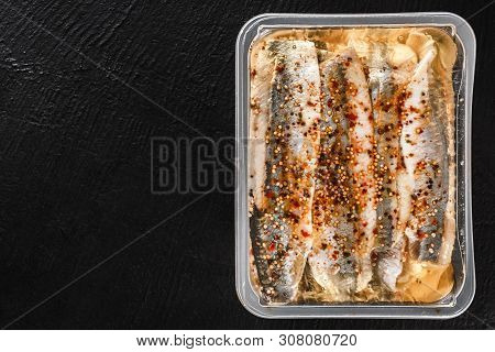 Marinated Fillet Mackerel Or Fillet Herring Fish With Spices Packed In Box On Slate Stone Background