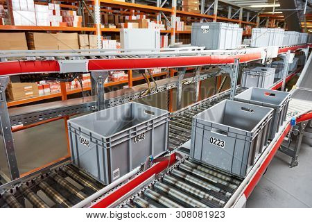 Automated warehouse. Boxes with spare parts moving on conveyer