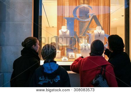 Paris, France - December 12, 2018: Tourists Doing Window Shopping And Admiring A Luxury Jewelry Bout