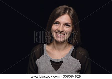 Close Up Portrait Of Young Woman Isolated On Black Studio Background. Photoshot Of Real Emotions Of 