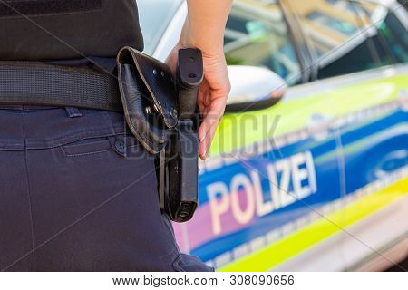 Female Police Officer Keeps Her Hand On Her Weapon. Polizei Is The German Word For Police