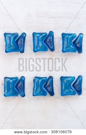 Set Of Blue Washing Detergent Capsule Isolated On White Wooden Background. Close-up.liquid Soap.