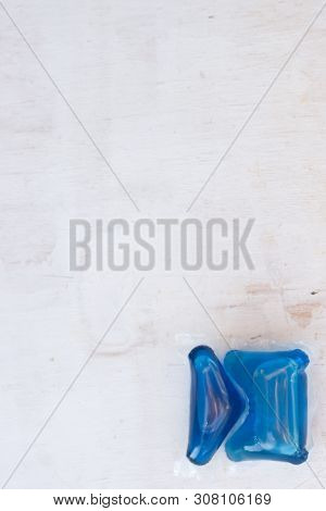 Set Of Blue Washing Detergent Capsule Isolated On White Wooden Background. Close-up.liquid Soap.