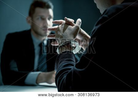 Criminal Man With Handcuffs Being Interviewed In Interrogation Room After Committed A Crime