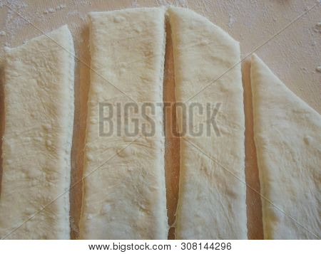 The Dough Is Cut Into Vertical Lines On A Wooden Board . Background. Vertical Line