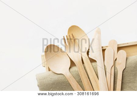 Wood Cutlery Spoons Fork Knife On Beige Linen Cloth White Wall Background. Zero Waste Plastic Free R