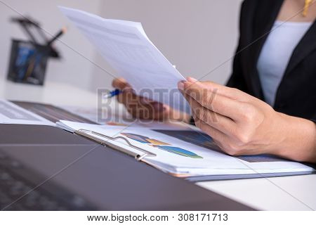 Businessman Analysis Comparing Financial Reports. Financial Reports Are Set Of Documents Prepared By