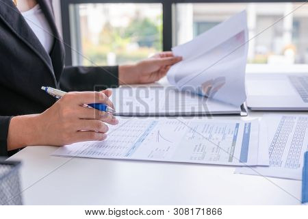 Businessman Analysis Comparing Financial Reports. Financial Reports Are Set Of Documents Prepared By