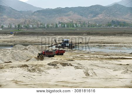 North Korea - April 30, 2019: Countryside.  Gold Mining On The River Taedong. Workers On The Dredge 