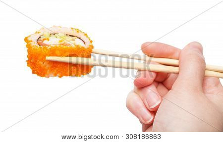 Female Hand With Wooden Chopsticks Holds California Ebi Sushi Roll Isolated On White Background