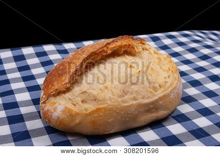 Artisan Traditional French Bread Lies On Table Covered With Rustic Style Checkered Blue White Tablec