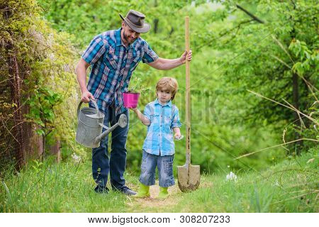 Dad Teaching Little Son Care Plants. Little Helper In Garden. Make Planet Greener. Growing Plants. T