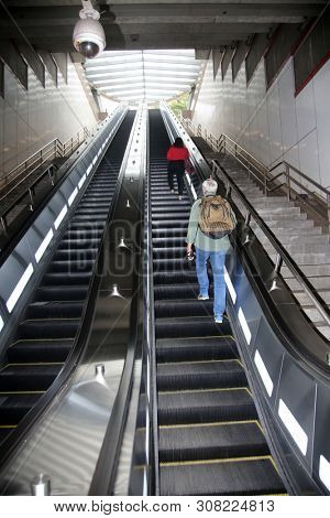 escalator. moving stairs going up and down for ease of pedestrian traffic.  