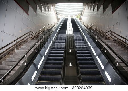 escalator. moving stairs going up and down for ease of pedestrian traffic.  