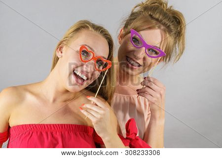 Happy Two Women Holding Paper Decoration Photo Booth Mask Glasses On Stick, Having Fun. Wedding, Bir