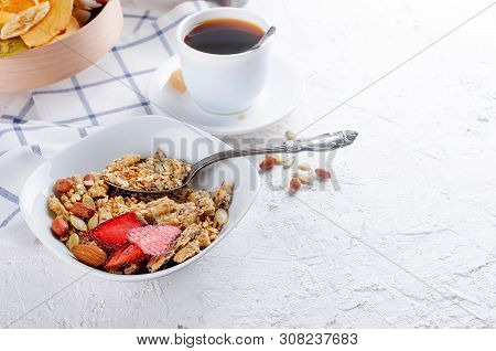 Granola From Several Types Of Cereals With Nuts,coconut Chips And Dried Fruits  In White Plate For B