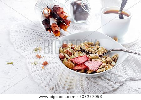 Granola From Several Types Of Cereals With Nuts,coconut Chips And Dried Fruits  In White Plate For B